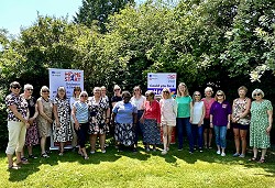 An image showing Home-start Chichester staff and volunteers standing outside in front of trees with Home-start Chichester banners An image showing Home-start Chichester staff and volunteers standing outside in front of trees with Home-start Chichester banners